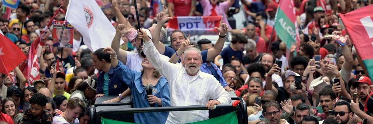 Then presidential candidate  Luiz Inacio "Lula" da Silva waves a national flag during a campaign rally in Belo Horizonte, Minas Gerais state, Brazil on October 9, 2022.