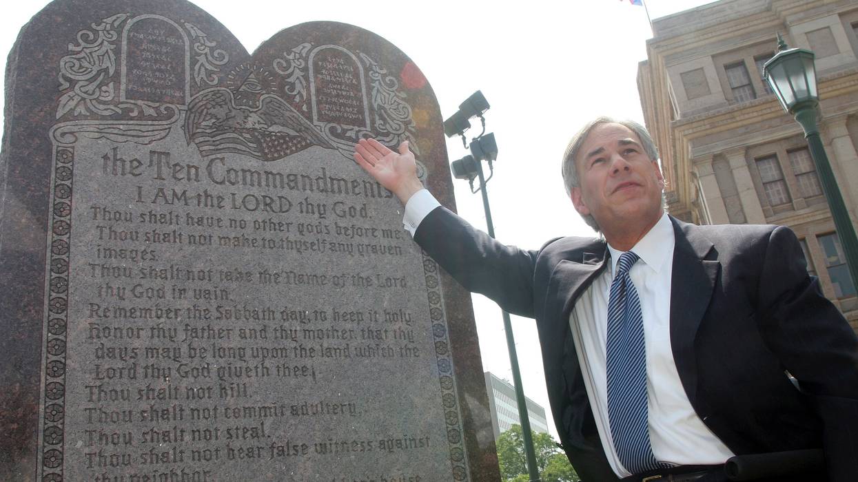 Then-Texas Attorney General Greg Abbott, now the state's governor, celebrates the U.S. Supreme Court decision that allows a Ten Commandments monument to stand outside the state capitol building in Austin on June 27, 2005.