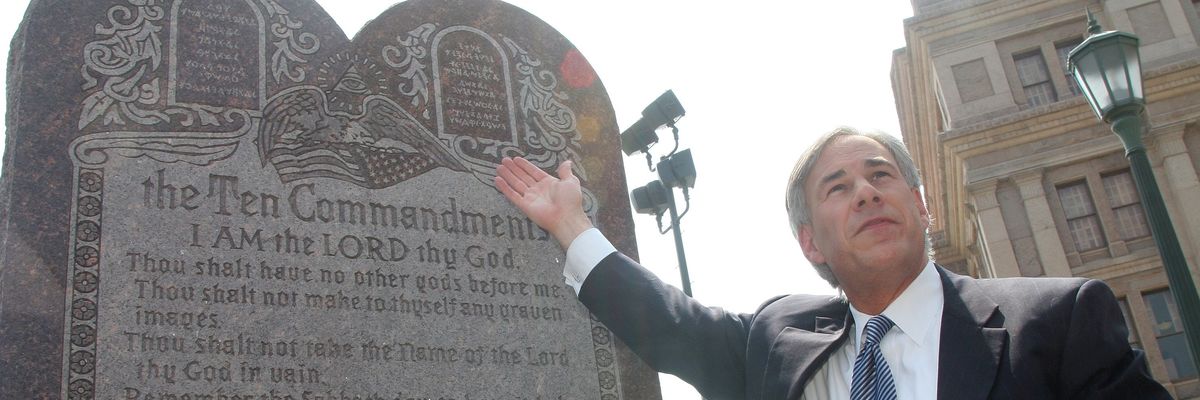 ​Then-Texas Attorney General Greg Abbott, now the state's governor, celebrates the U.S. Supreme Court decision that allows a Ten Commandments monument to stand outside the state capitol building in Austin on June 27, 2005.