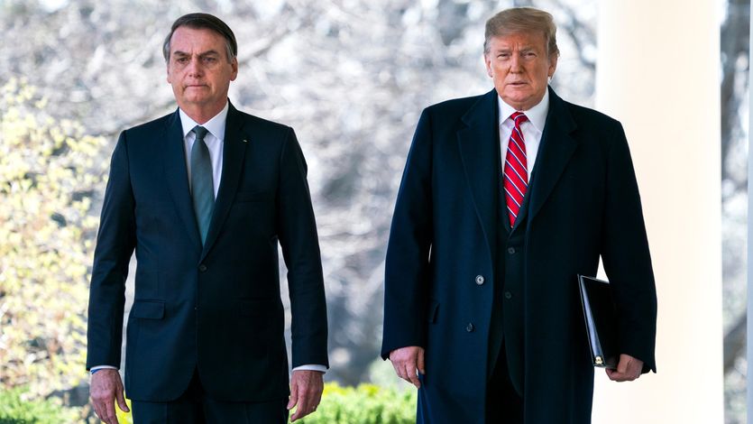 Then-U.S. President Donald Trump walks with Brazilian President Jair Bolsonaro