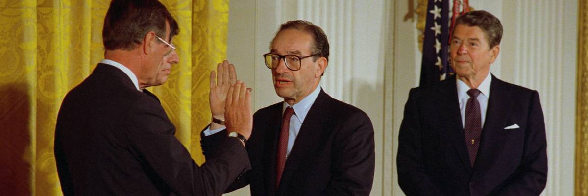 Then-Vice President George H. W. Bush swears in Alan Greenspan while President Ronald Reagan looks on.