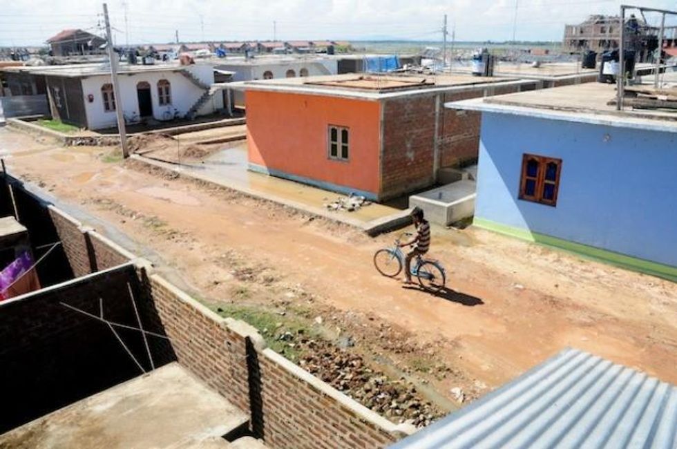 These half-built houses, part of a rehabilitation village in Kalmunai, were built using private funds. (Photo: Amantha Perera/IPS)