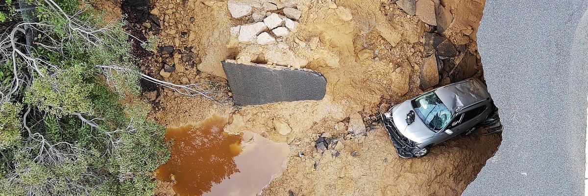 This aerial view shows cars that fell into a large sinkhole