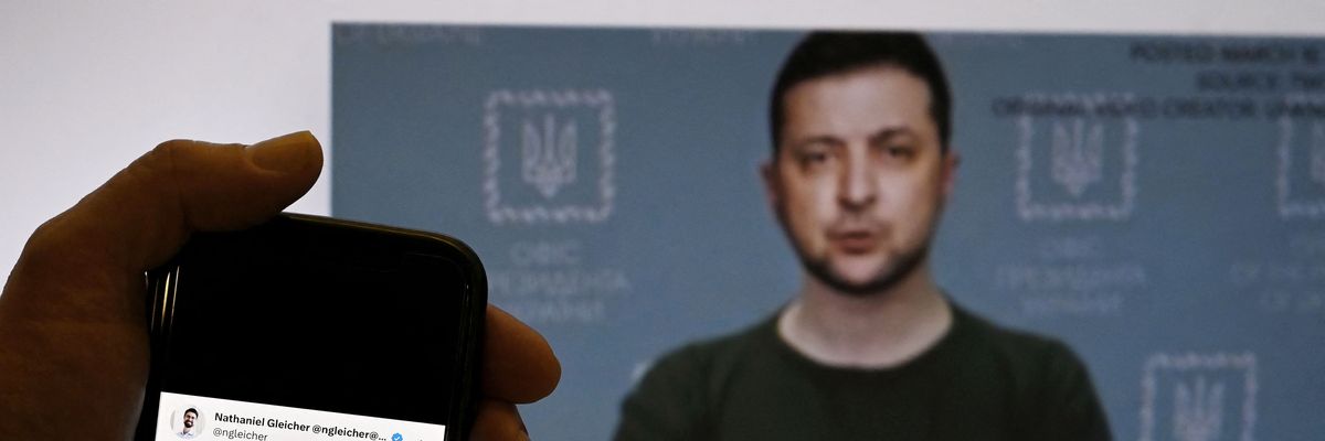 ​This photo taken in Washington, D.C. on January 30, 2023 shows a phone screen displaying a statement from Meta's head of security policy in front of a fake video of Ukrainian President Volodymyr Zelenskyy calling on his soldiers to lay down their weapons.