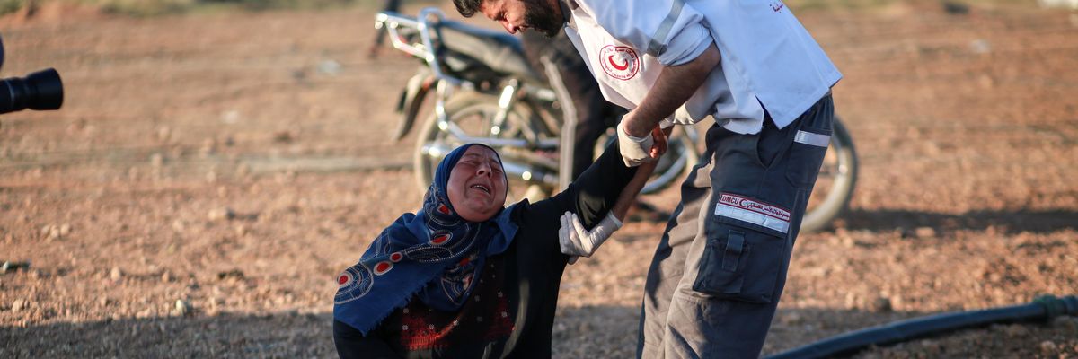 This photograph, taken by a freelancer recently terminated by The New York Times, shows a paramedic attending to a woman injured by Israeli forces during a protest along the border with Israel, east of Gaza City, on April 1, 2018.