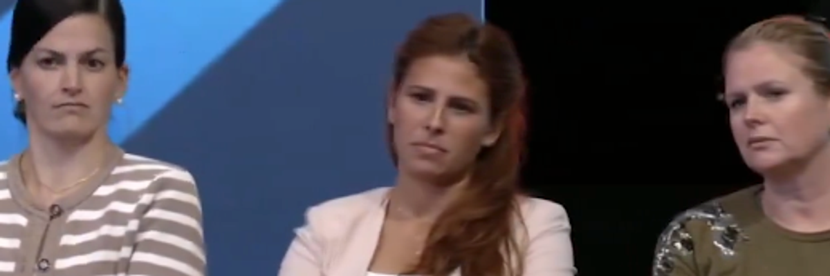 Three audience members react after Republican presidential candidate Donald Trump calls January 6, 2021 a "day of love"