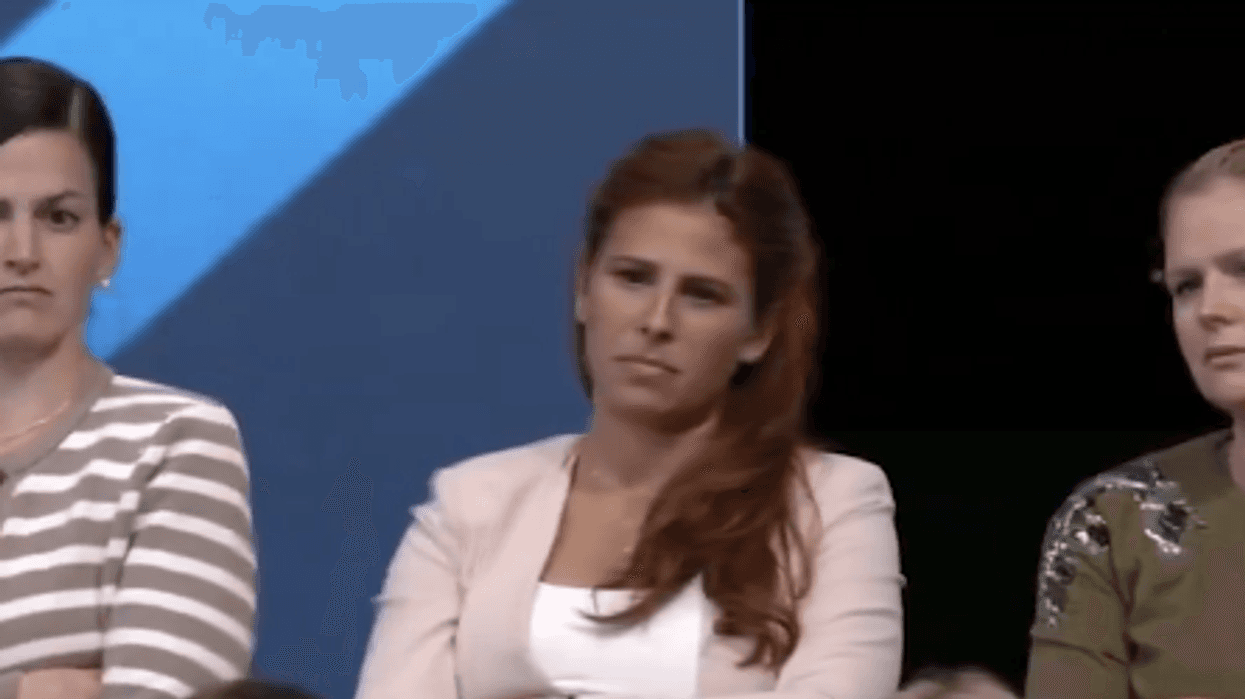 Three audience members react after Republican presidential candidate Donald Trump calls January 6, 2021 a "day of love"