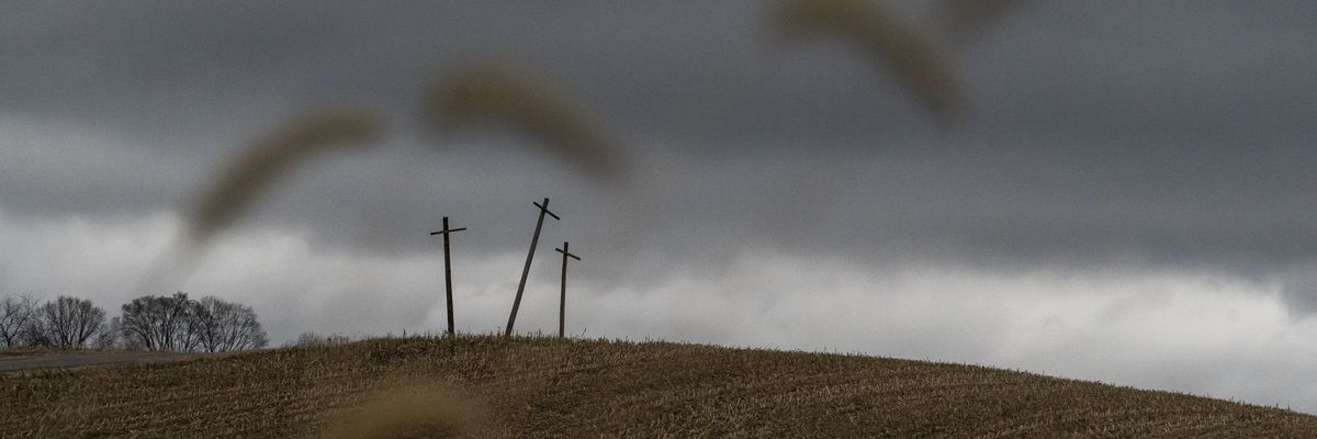 Three crosses stand on a hillside overlooking a farm on the state line of Ohio and Pennsylvania following a train derailment on February 17, 2023.