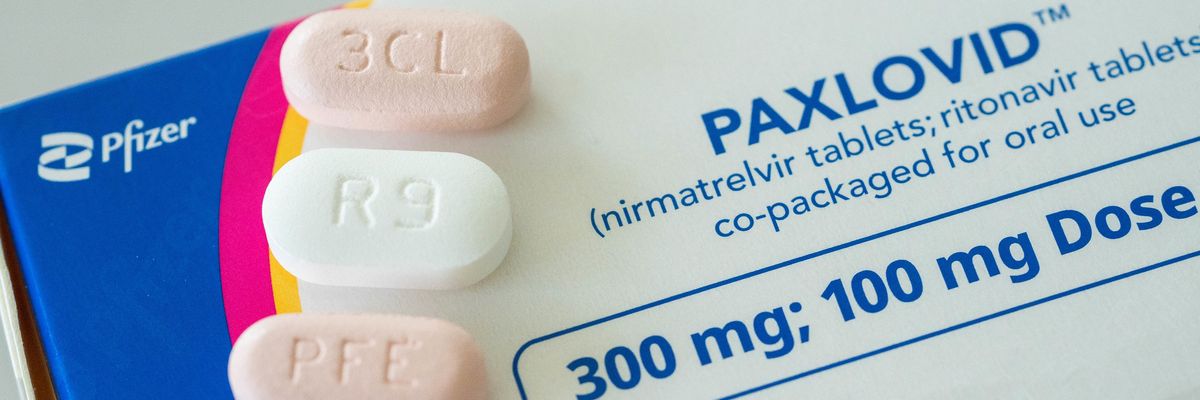 Three Paxlovid pills sit on a box of the Pfizer treatment for Covid-19