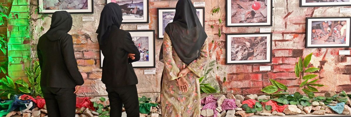 Three woman look at photographs.