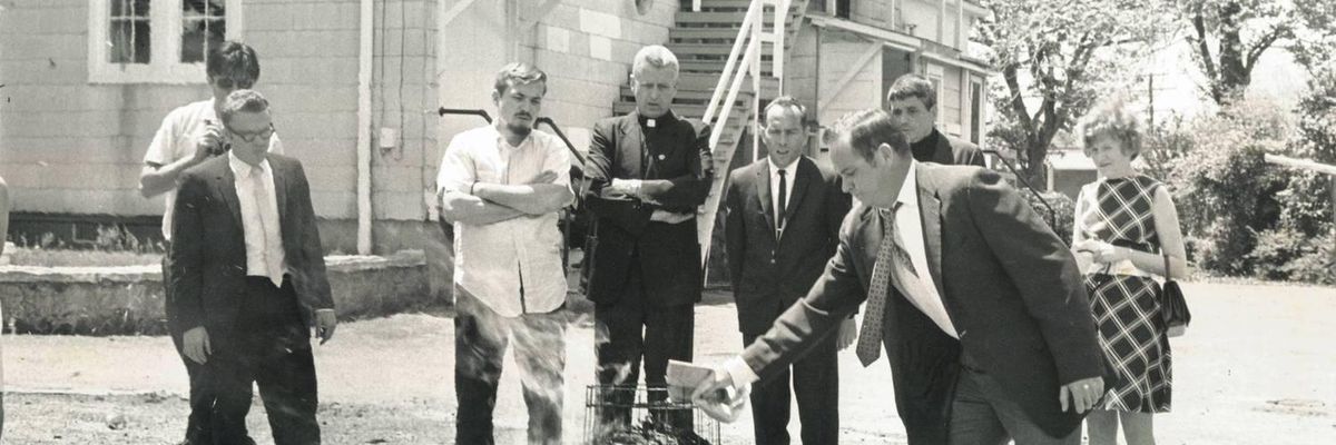 Tom Melville puts more fuel on the burning draft cards at the Selective Service office in Catonsville on May 17, 1968