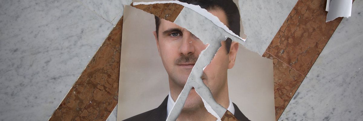 Torn picture of Bashar al-Assad after fall.