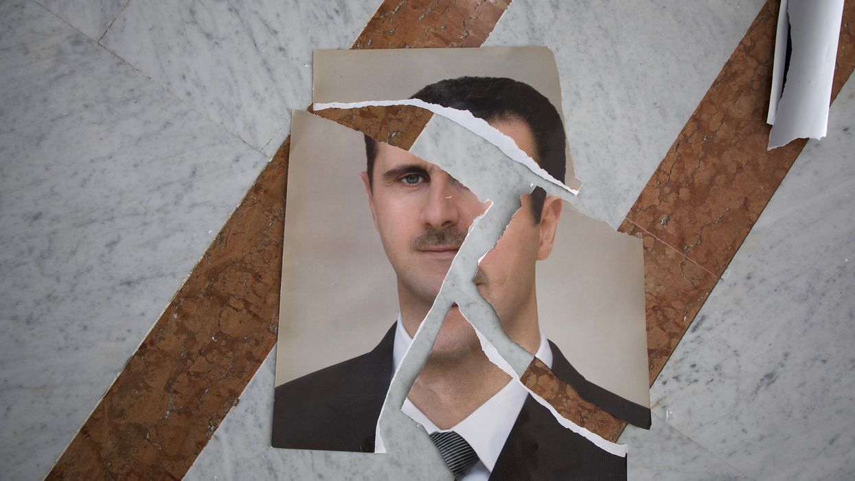 Torn picture of Bashar al-Assad after fall.