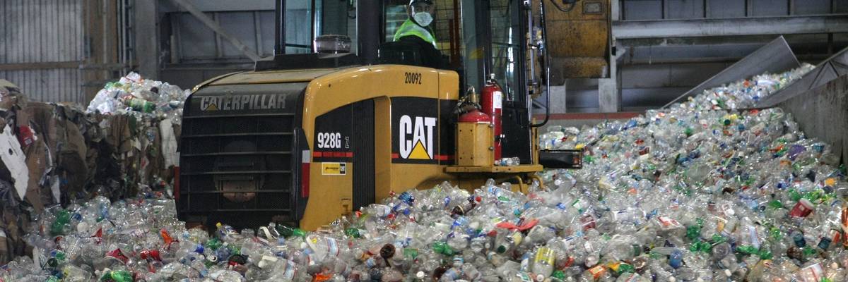 tractor inside pile of plastic water bottles