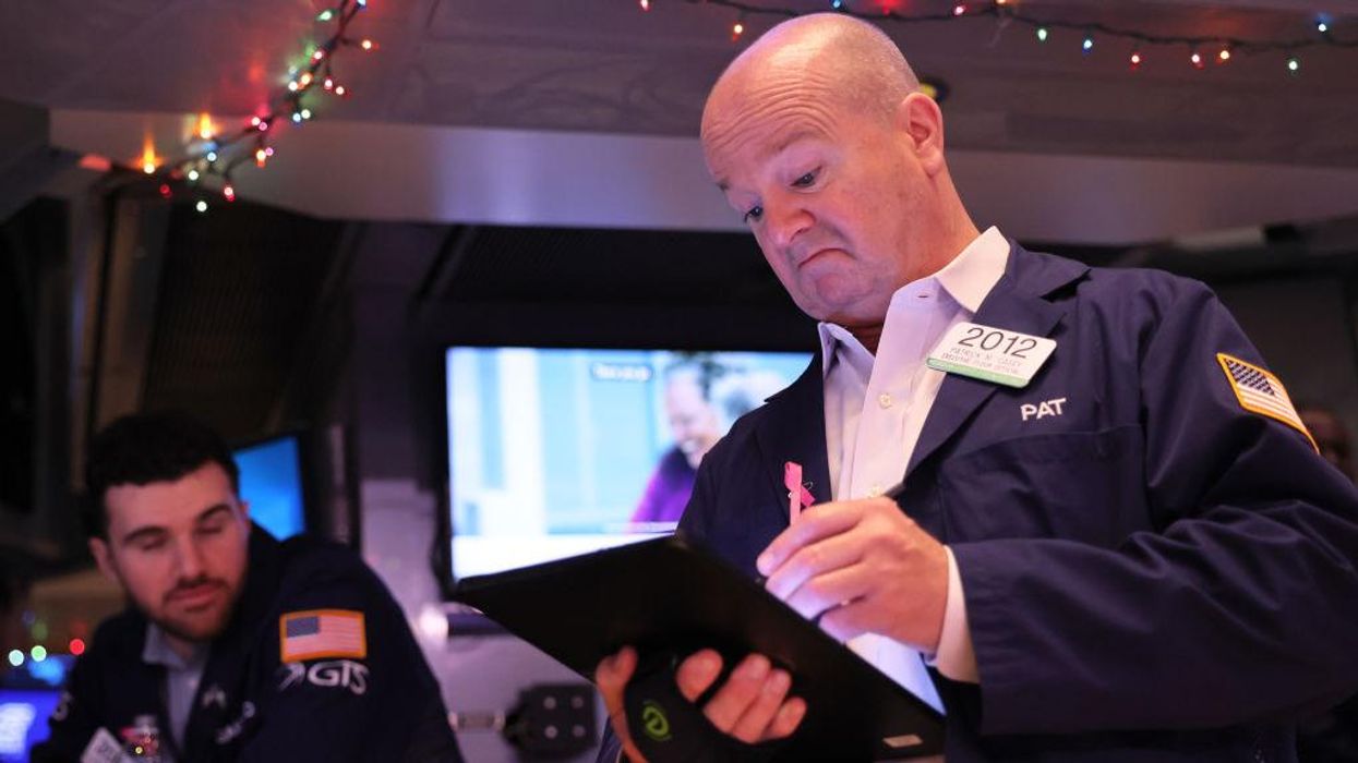 Traders work on the floor of the New York Stock Exchange