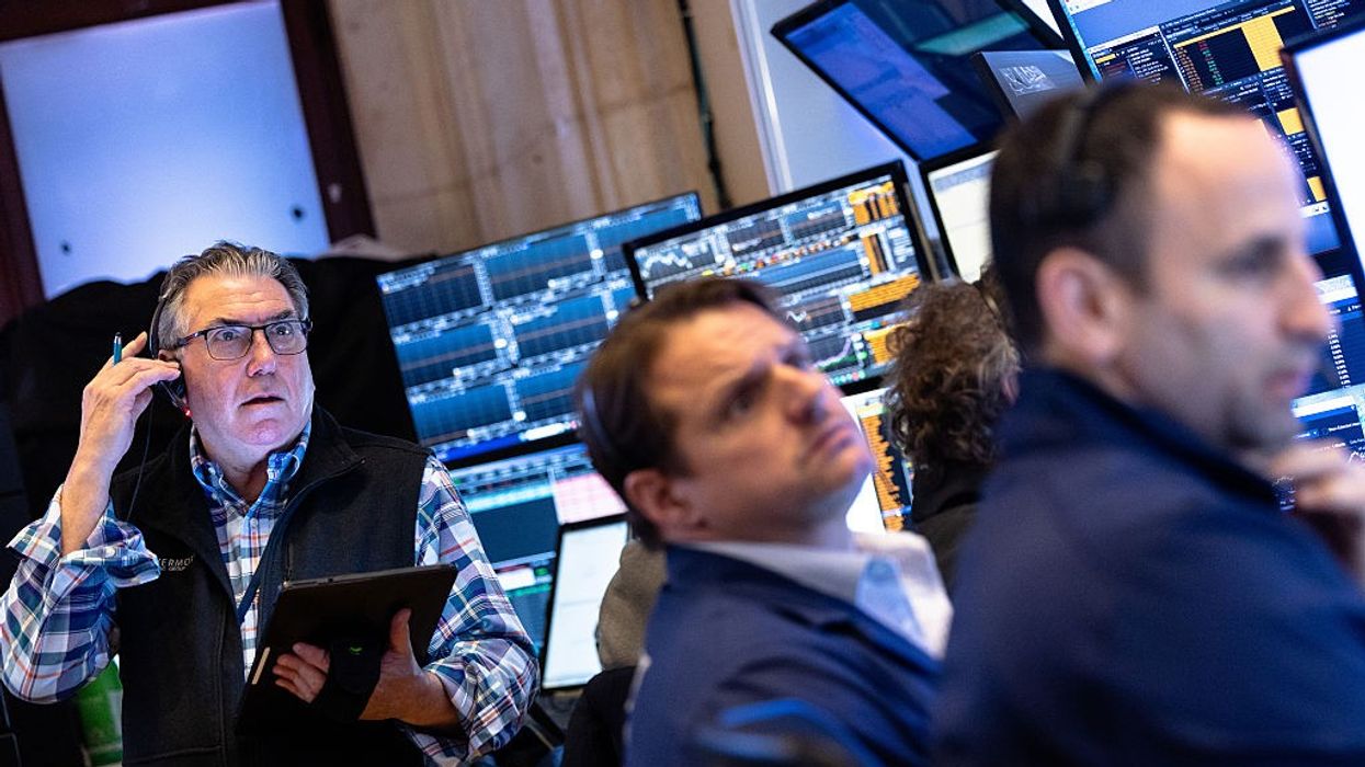 Traders work on the floor of the New York Stock Exchange