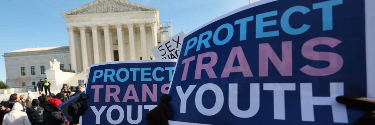 Transgender rights supporters rally outside of the U.S. Supreme Court