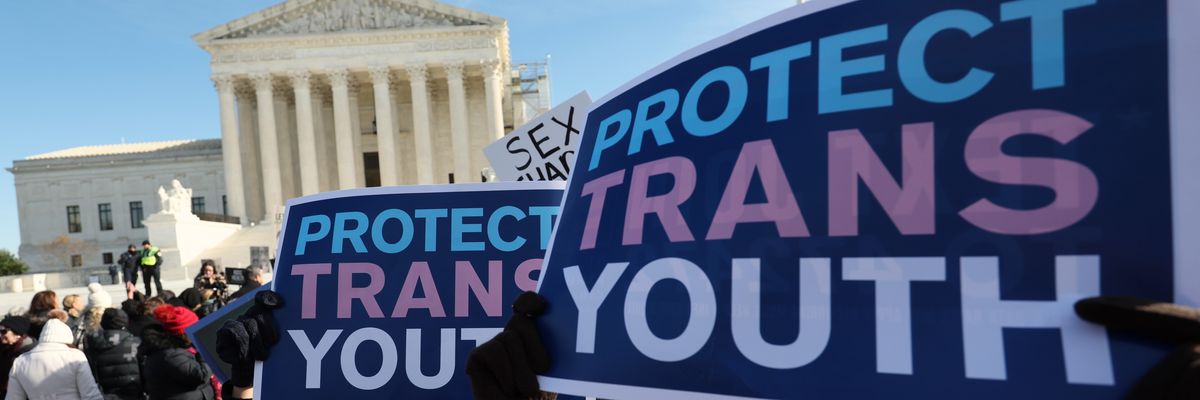 Transgender rights supporters rally outside of the U.S. Supreme Court
