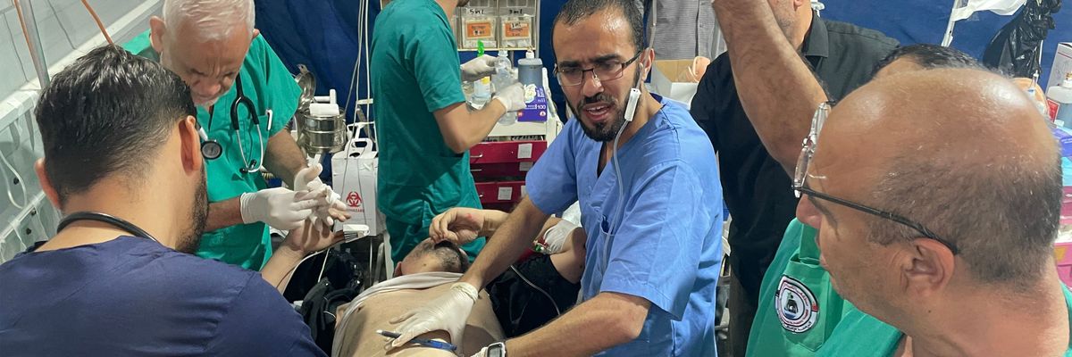 Trauma surgeons and other medical staff rush to try to save a woundeed Palestinian man's life.