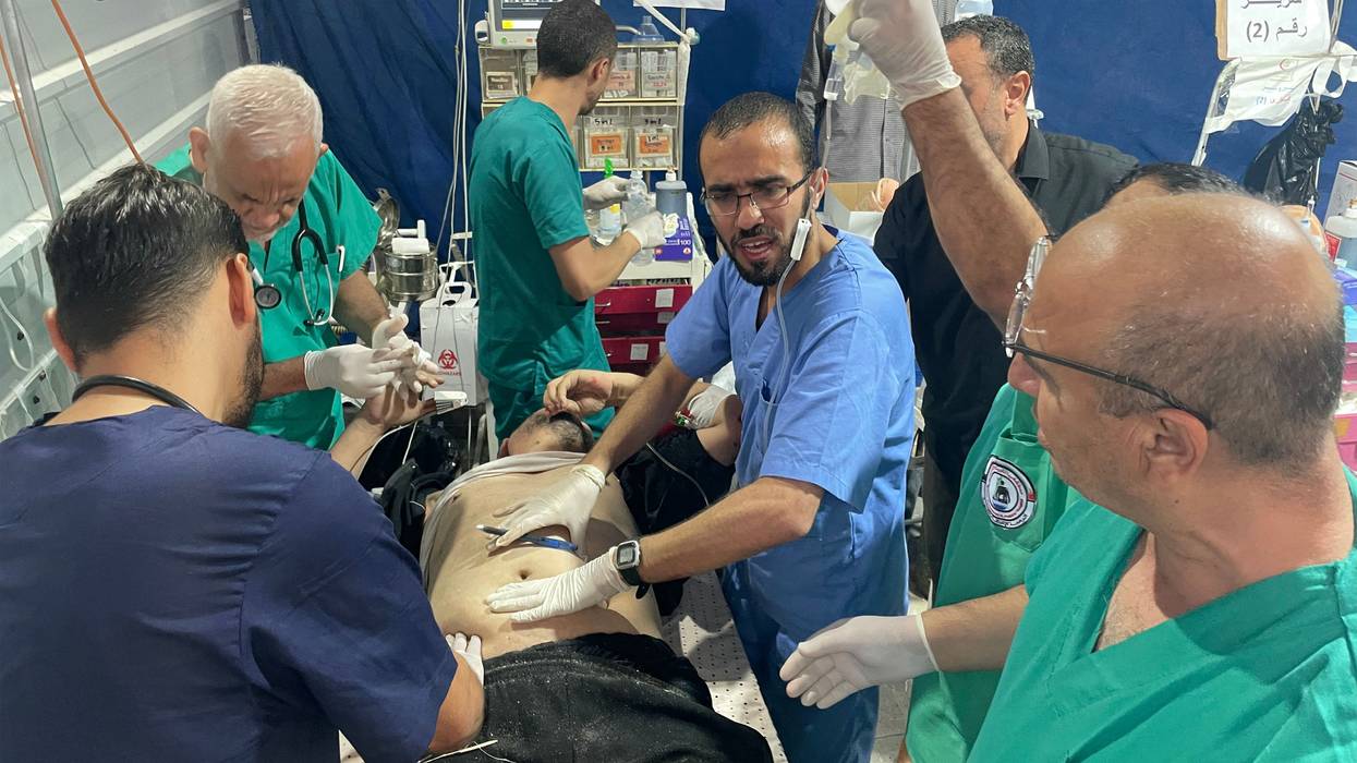 Trauma surgeons and other medical staff rush to try to save a woundeed Palestinian man's life.