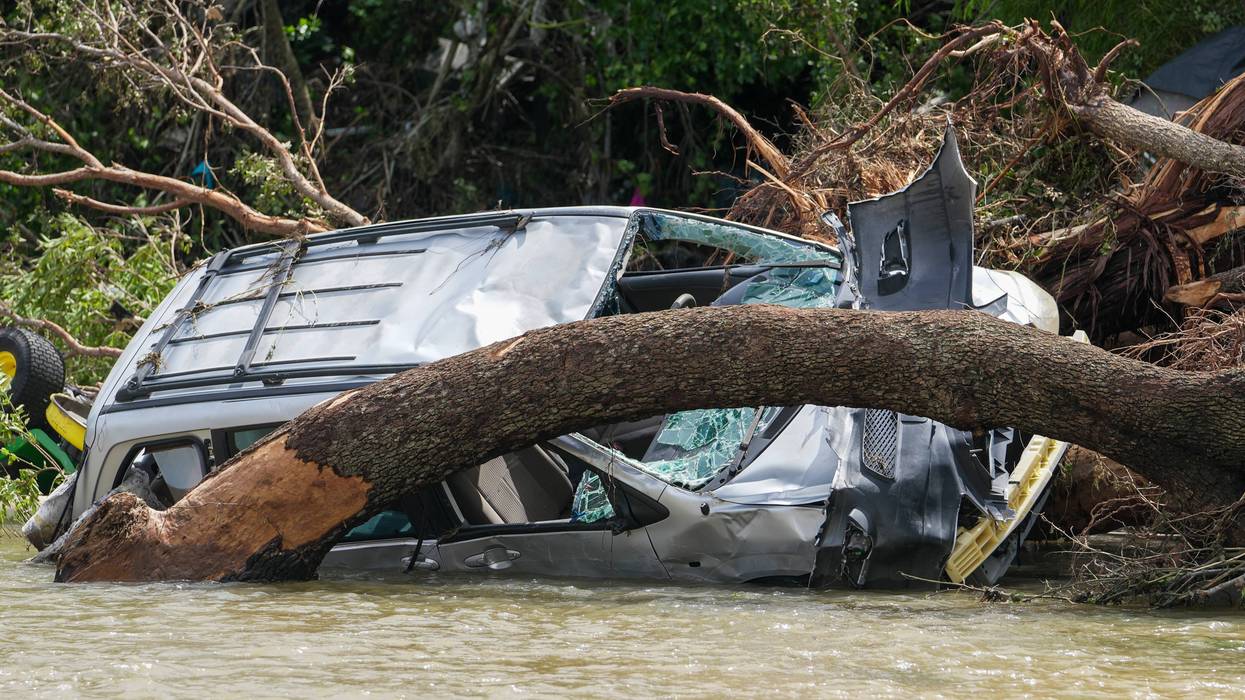 Travis County Flood recovery - Destroyed vehicles sit in flood waters