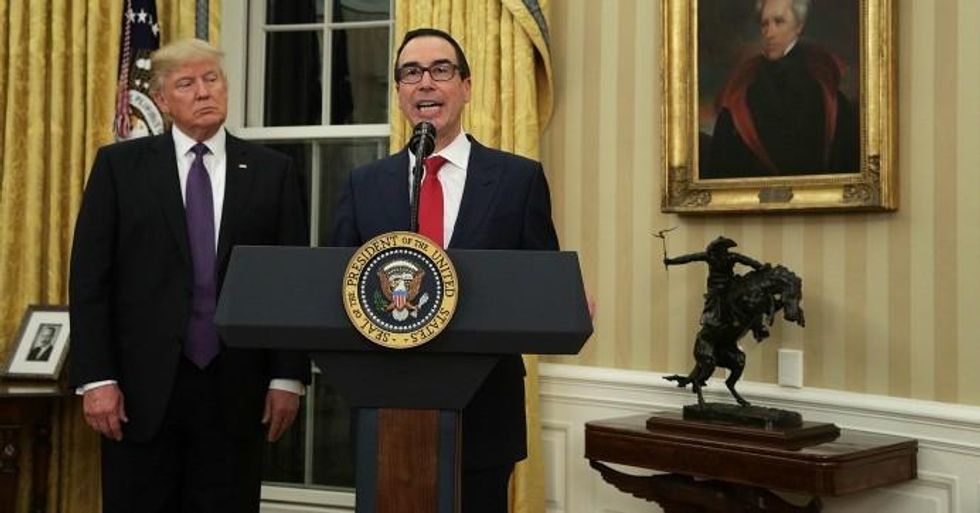 Treasury Secretary Steve Mnuchin speaks as US President Donald Trump looks on during a swearing-in ceremony in the Oval Office in Washington, D.C. (Photo: Alex Wong/Getty Images)