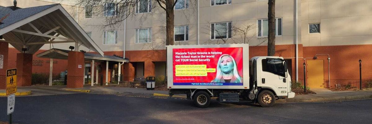 Truck protesting Marjorie Taylor Greene for threatening benefits.