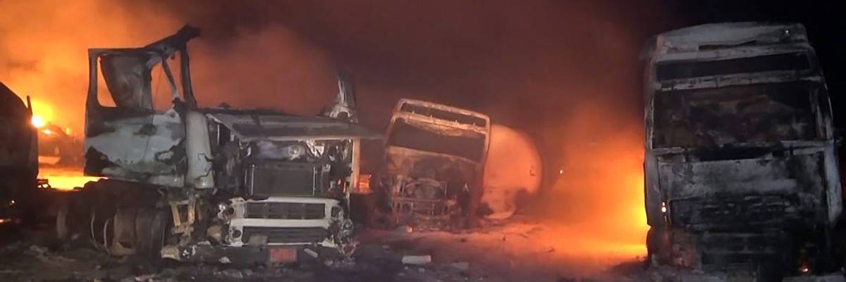 Trucks burn after U.S. forces bombed the Ras Isa oil port in Yemen