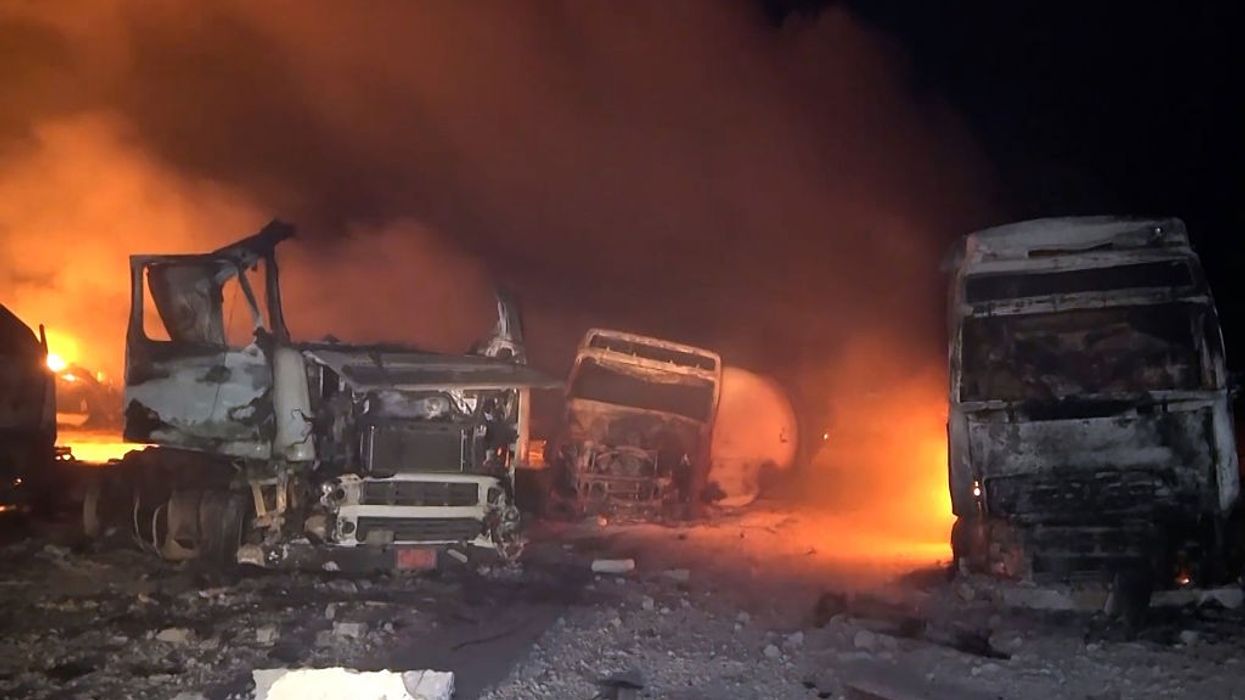 Trucks burn after U.S. forces bombed the Ras Isa oil port in Yemen