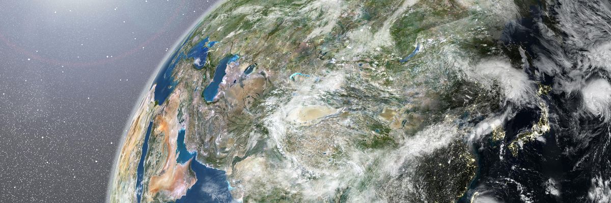 True colour satellite image of the Earth showing Asia, half in shadow, with cloud coverage, and the sun. This image in orthographic projection was compiled from data acquired by LANDSAT 5 & 7 satellites., Globe Showing Asia, True Colour Satellite Image (Photo by Planet Observer/Universal Images Group via Getty Images)