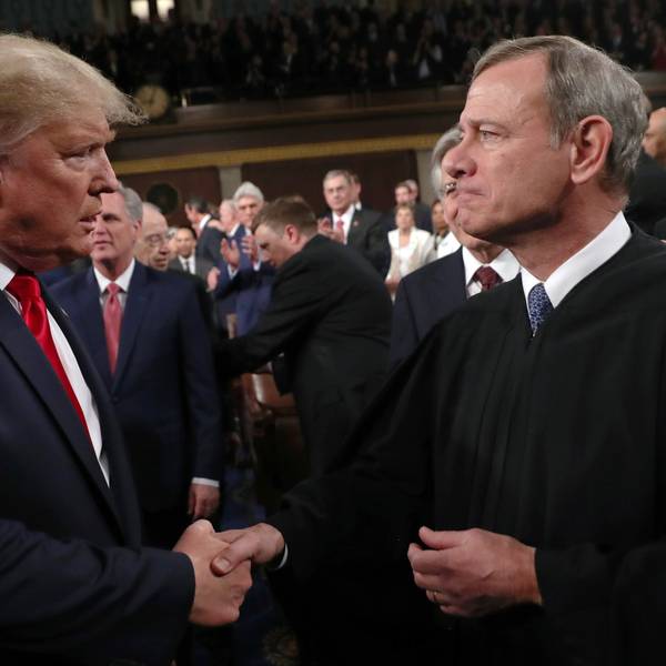 Trump and Roberts shake hands.