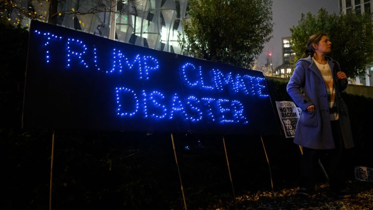 "Trump Climate Disaster" sign outside US Embassy