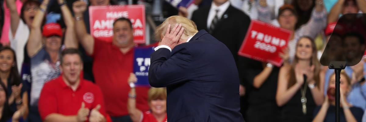 Trump covers his ears.