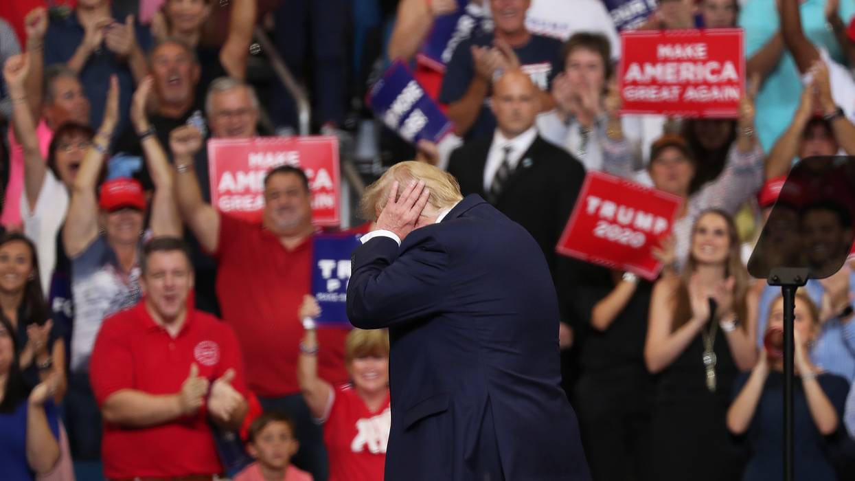 Trump covers his ears.