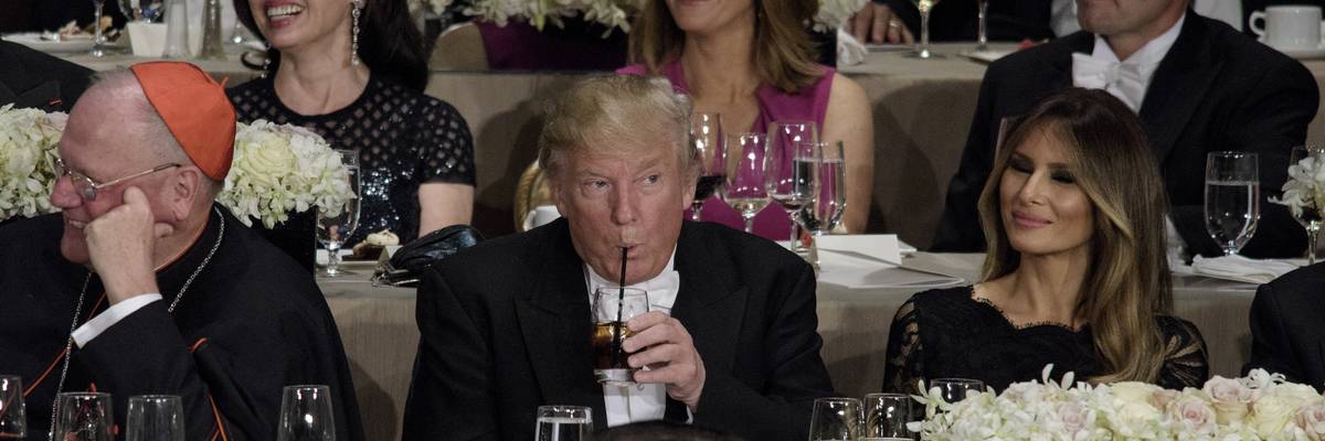 Trump drinks from plastic straw.
