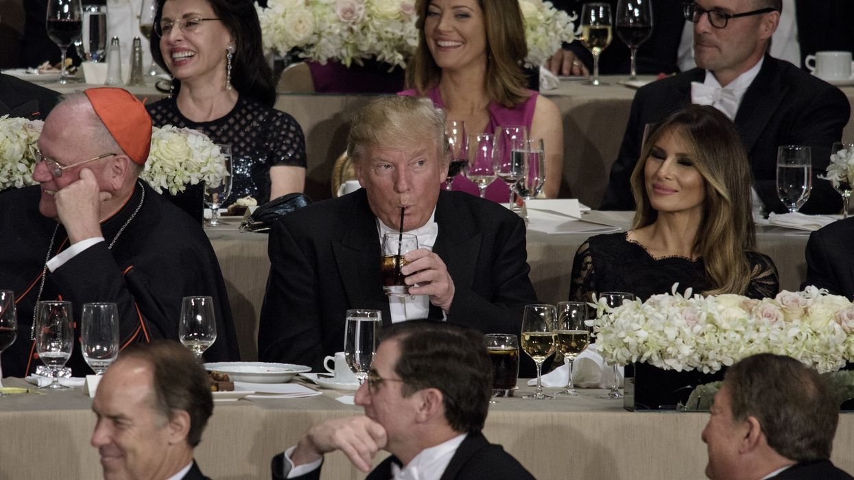 Trump drinks from plastic straw.