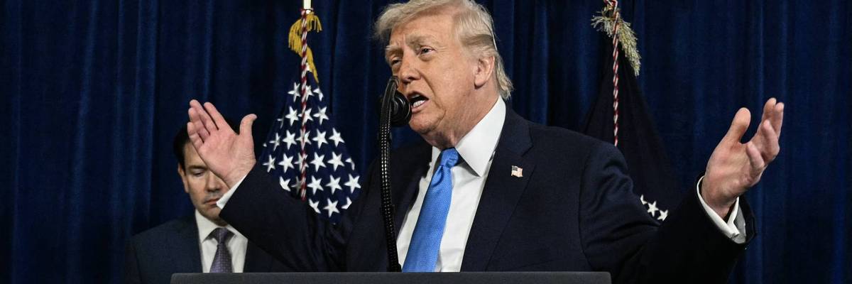 Trump gestures as he speaks to the press.