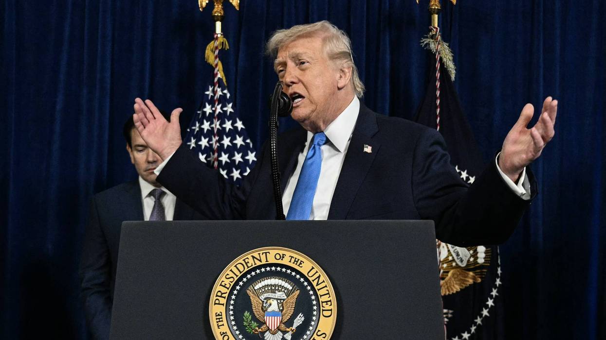 Trump gestures as he speaks to the press.