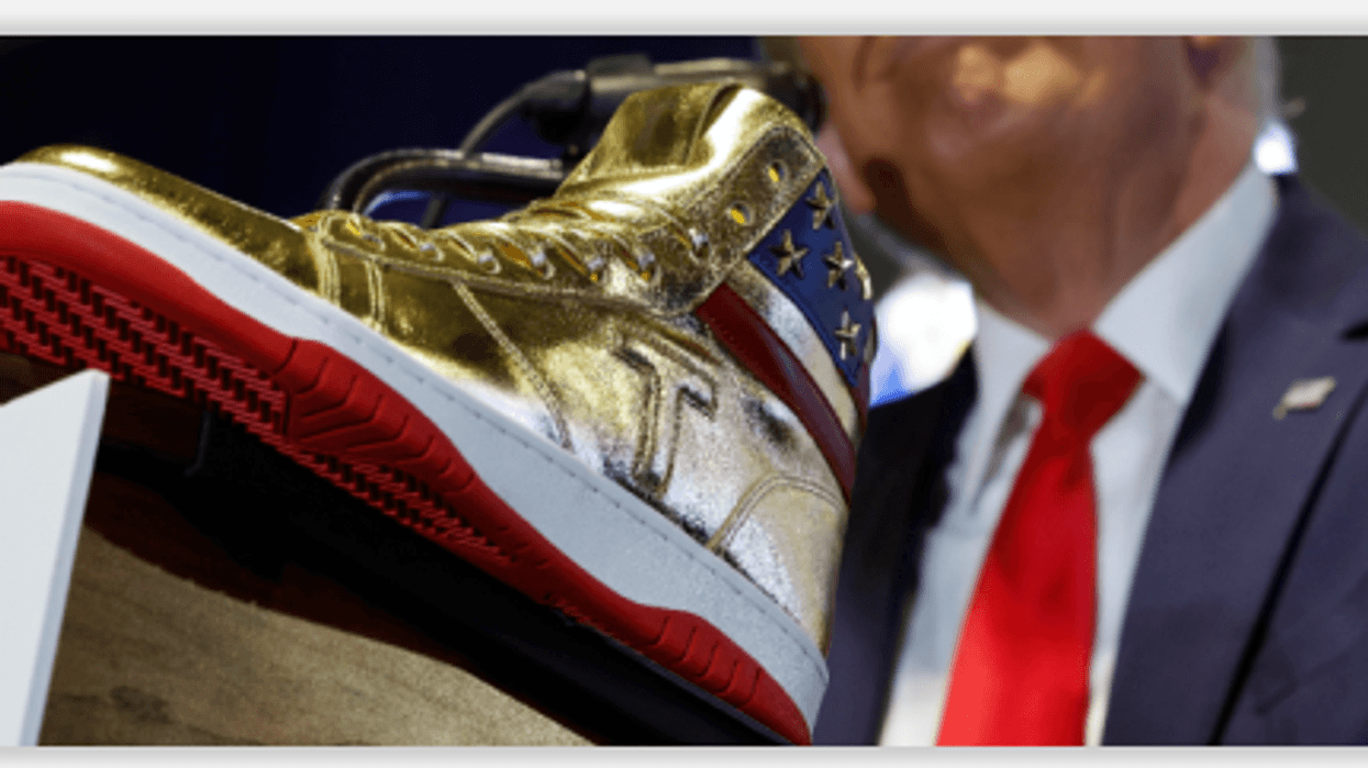 Trump hawks a gold high top at Sneaker Com in Philadelphia a day after he was ordered to pay $354 in a civil fraud suit