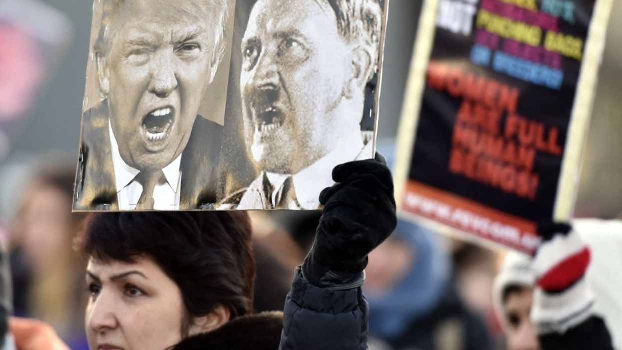 Trump Hitler on one sign