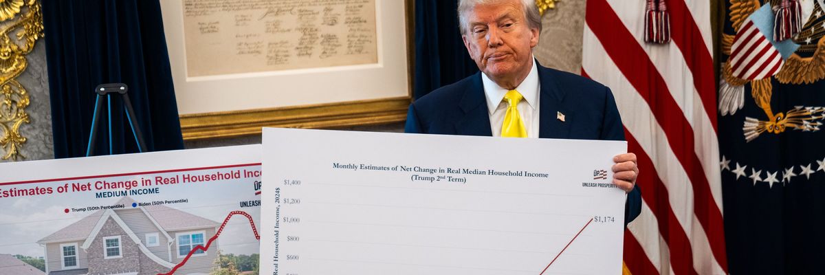 Trump holds a chart with economic data