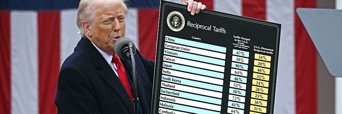 Trump holds a chart with tariff rates for various countries