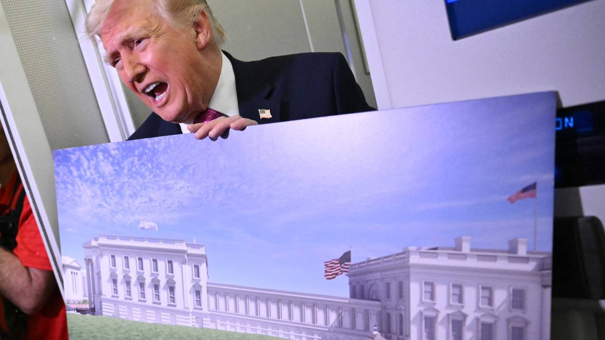 Trump holds a rendering of his East Wing remodel.