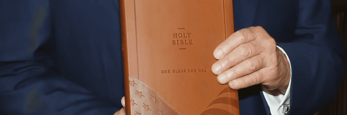Trump holds his Bible.