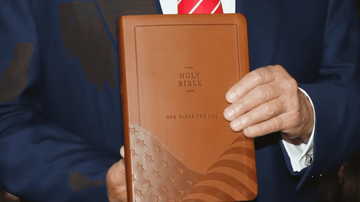 Trump holds his Bible.