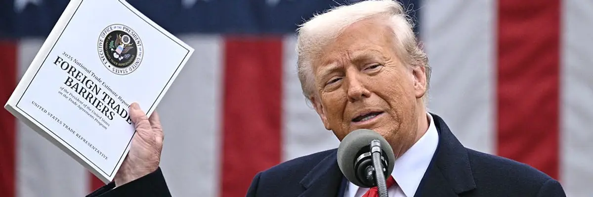 Trump holds up a report on his tariffs.