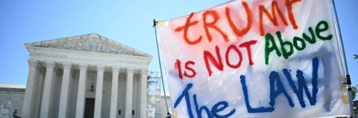 "Trump is not above the law" sign in front of Supreme Court