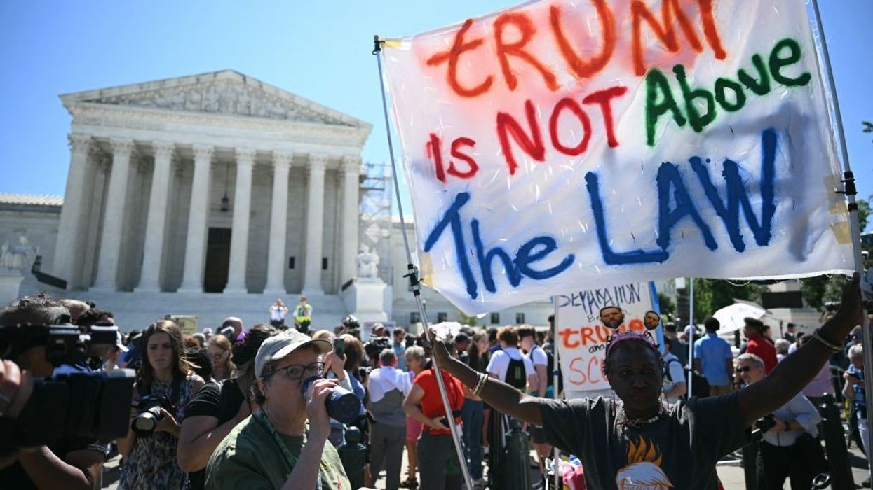 "Trump is not above the law" sign in front of Supreme Court