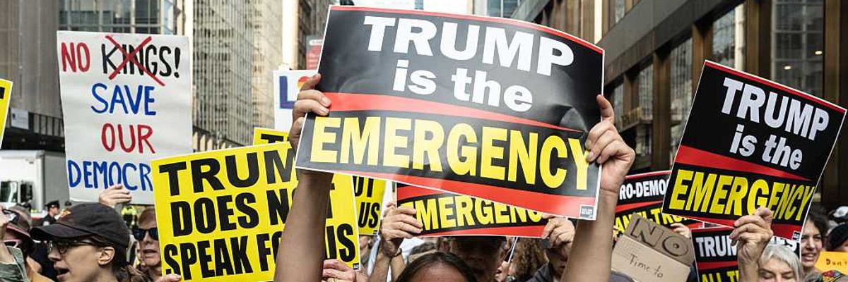 "Trump is the emergency," sign says of the fascist president