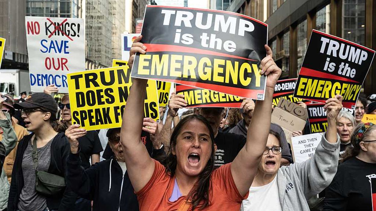 "Trump is the emergency," sign says of the fascist president